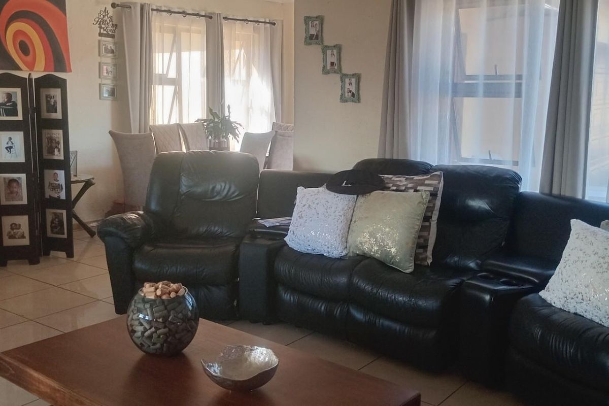 Spacious living area featuring neutral tiled flooring and large windows that allow for ample natural light.