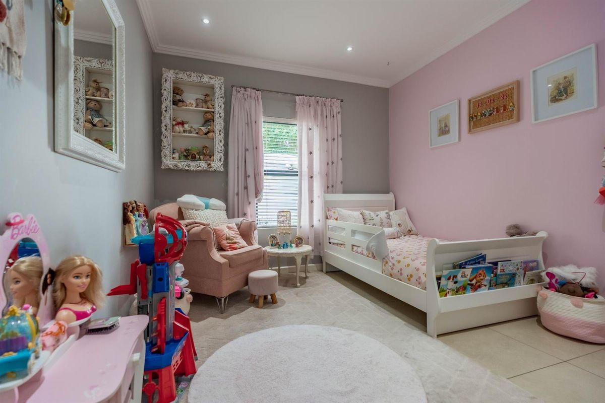 A well-maintained bedroom featuring recessed ceiling lighting, tiled flooring, and a built-in wall niche, offering a bright and functional living space.
