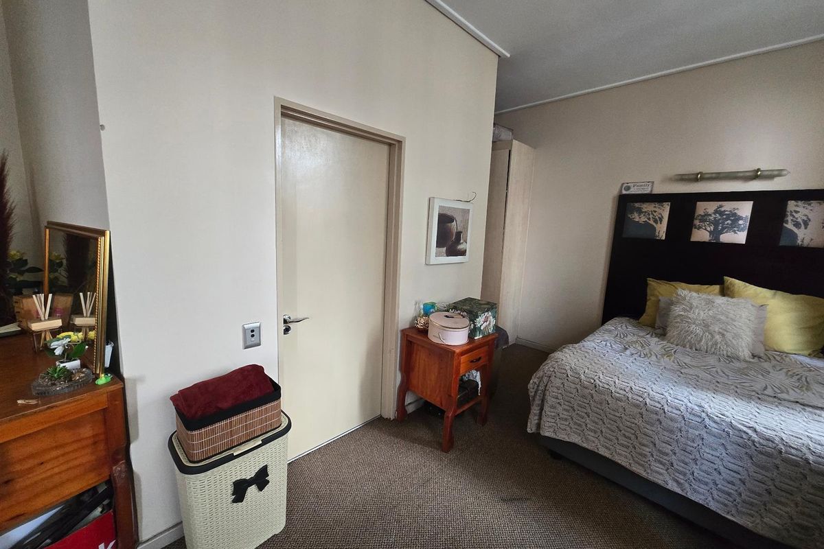 A standard bedroom featuring carpeted flooring and a neutral wall finish, providing a functional space for rest.