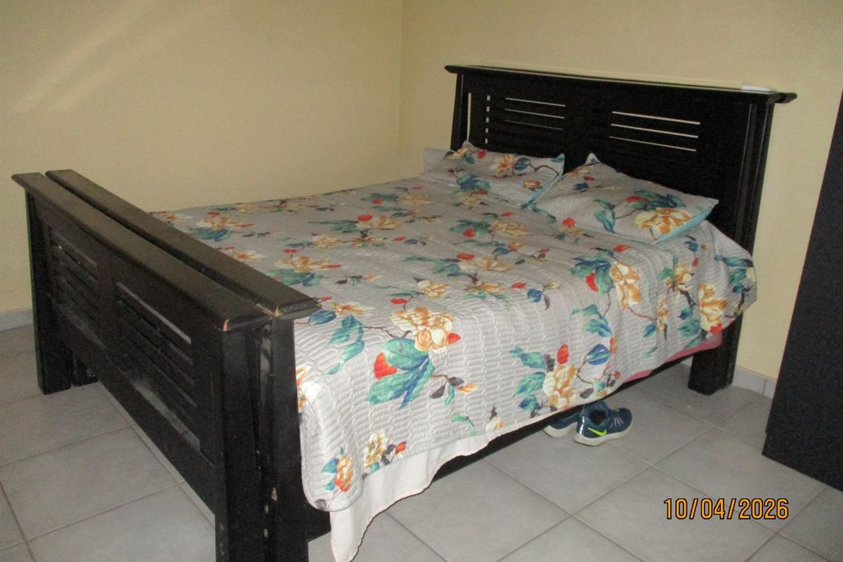 A bedroom featuring tiled flooring and neutral wall finishes.