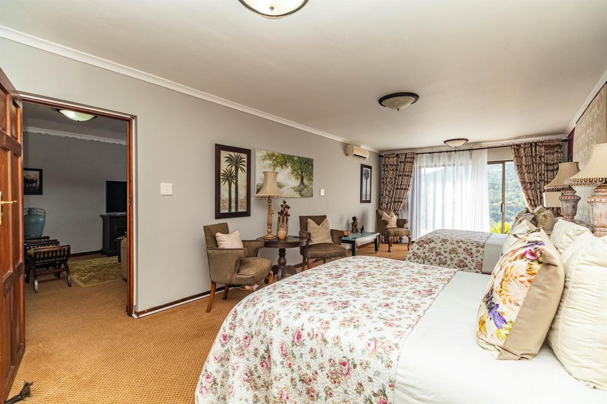 Spacious bedroom featuring wall-to-wall carpeting, a split-system air conditioning unit, and sliding glass doors providing access to an outdoor area.