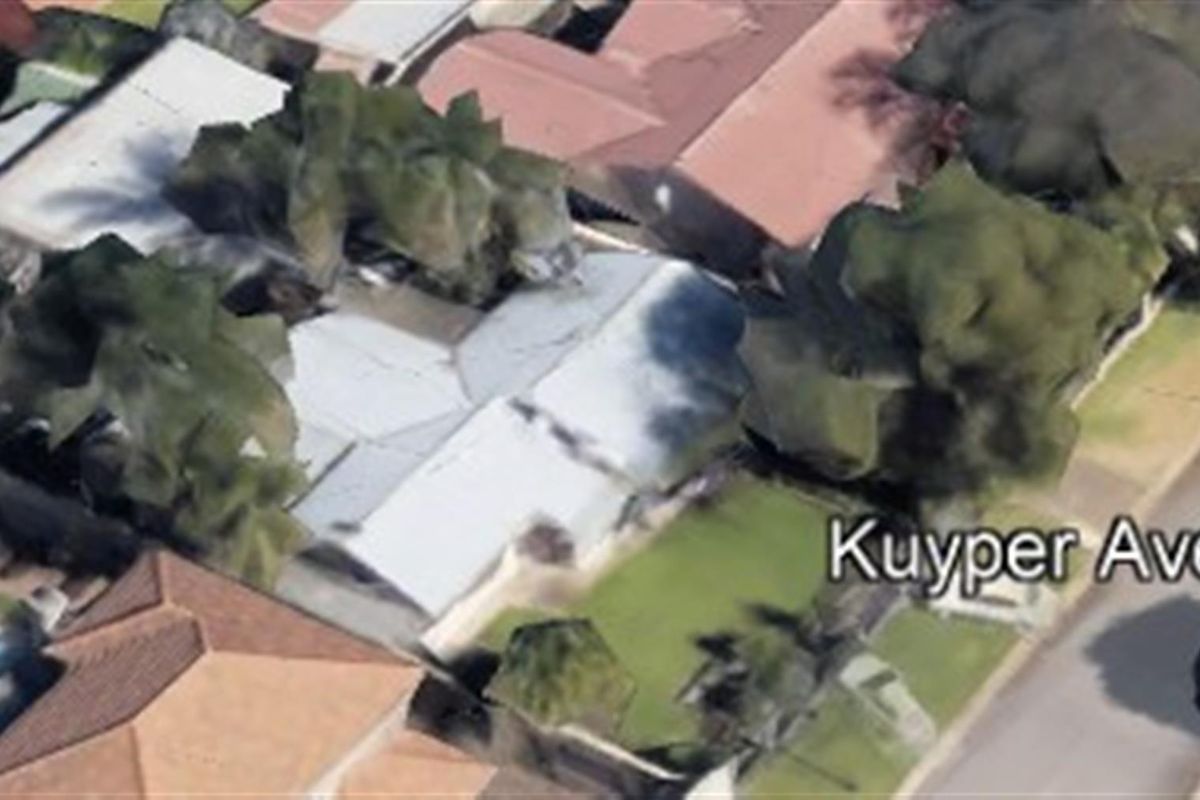 An aerial view of the property and surrounding neighbourhood, showing the roof structure and garden layout.