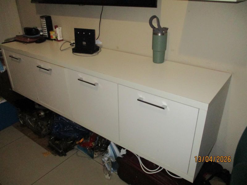 A close-up view of a white wall-mounted storage unit in a living area.