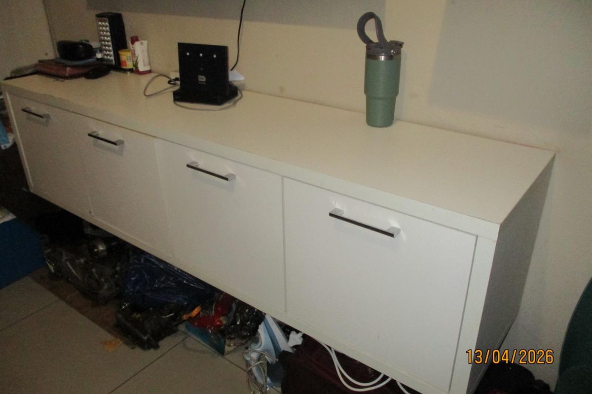 A close-up view of a white wall-mounted storage unit in a living area.