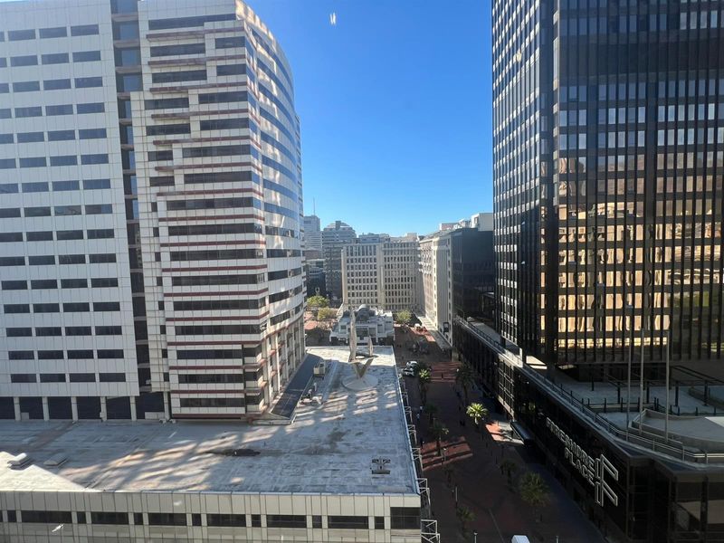 An elevated urban view overlooking surrounding high-rise office buildings and city street infrastructure.