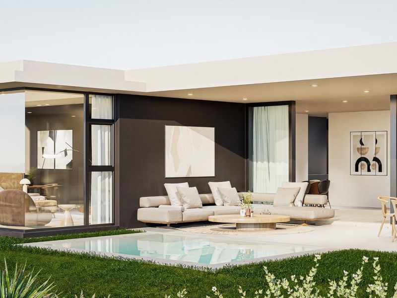 Modern outdoor living area featuring a covered patio, swimming pool, and seamless indoor-outdoor flow through large sliding glass doors.