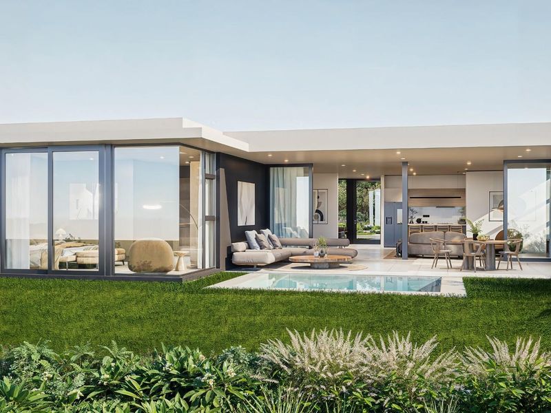 Modern rear exterior view featuring a covered patio, swimming pool, and large sliding glass doors connecting the indoor and outdoor living spaces.