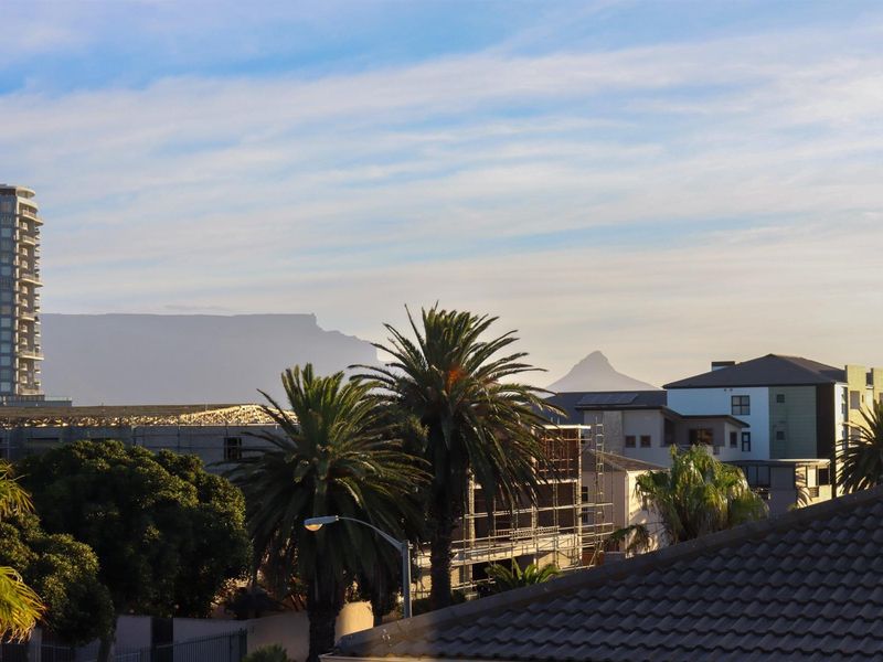 A scenic elevated view overlooking the surrounding urban landscape with prominent mountain vistas in the distance.