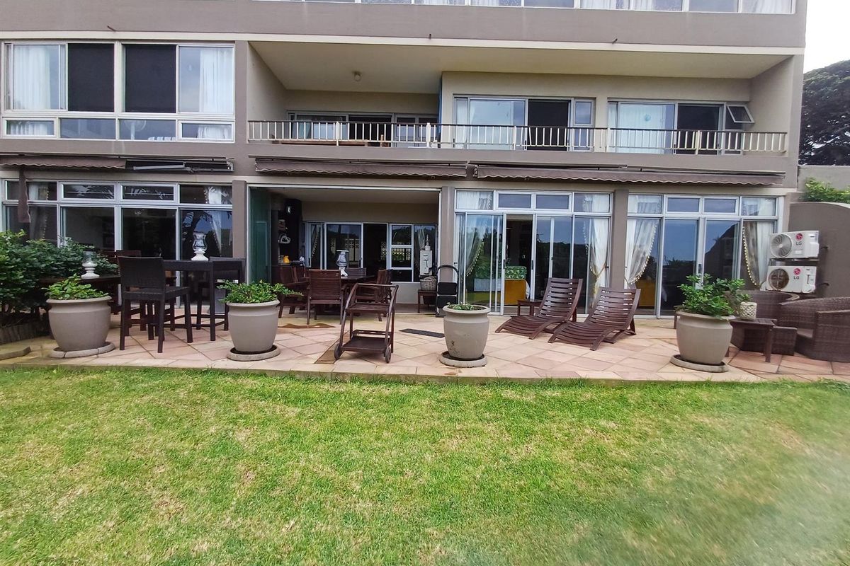 Spacious ground floor patio area with tiled flooring, providing seamless indoor-outdoor flow through large sliding glass doors to the garden.