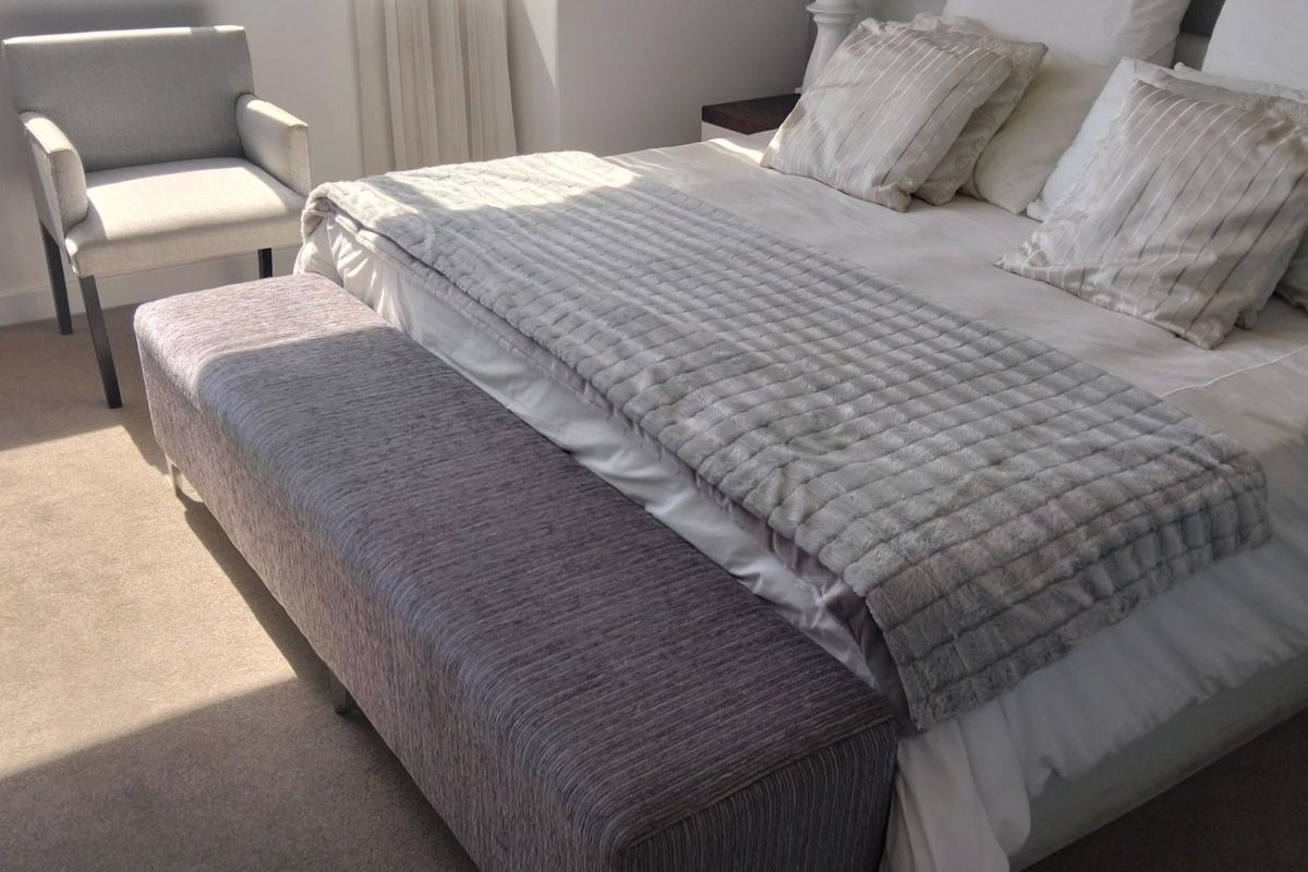 A bright and well-maintained bedroom featuring neutral carpeting and clean wall finishes, offering a comfortable and inviting living space.