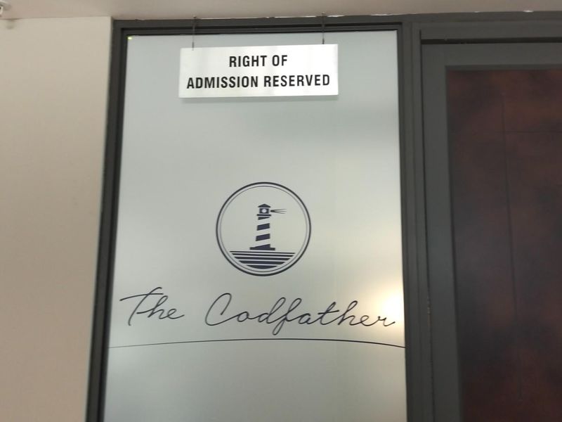 Entrance door featuring frosted glass panel with signage and branding for The Codfather.