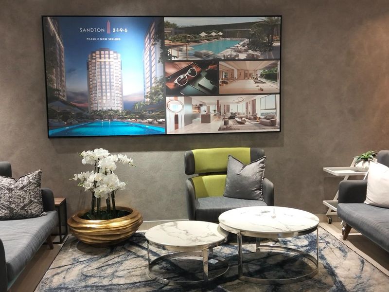 A modern, well-appointed lounge area featuring textured feature walls and contemporary interior design, suitable for a professional reception or residential common space.