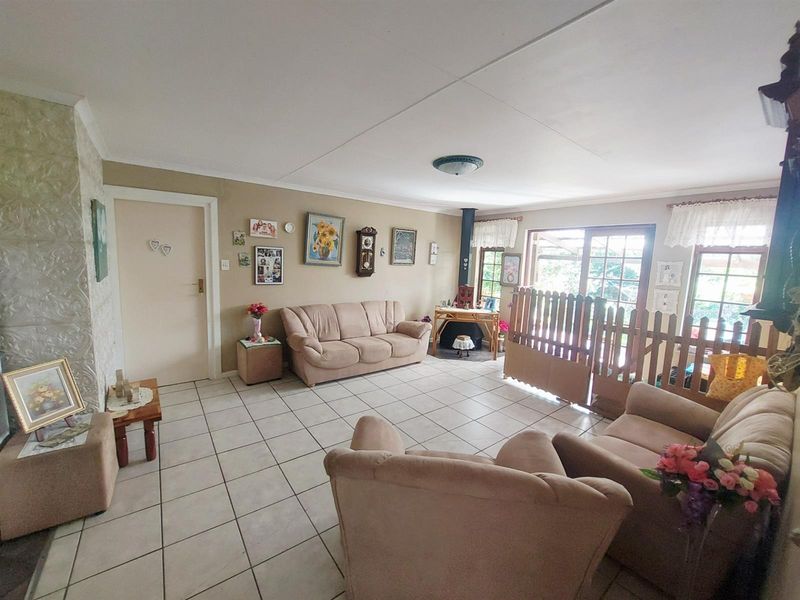Spacious living room featuring tiled flooring, a fireplace, and large sliding glass doors providing natural light and access to the outdoor area.