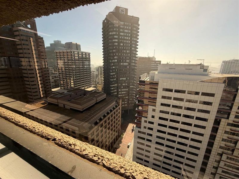 An elevated urban view looking out over surrounding high-rise office buildings and city streets.