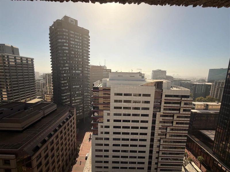 An elevated urban cityscape view showcasing surrounding high-rise office buildings and metropolitan infrastructure.