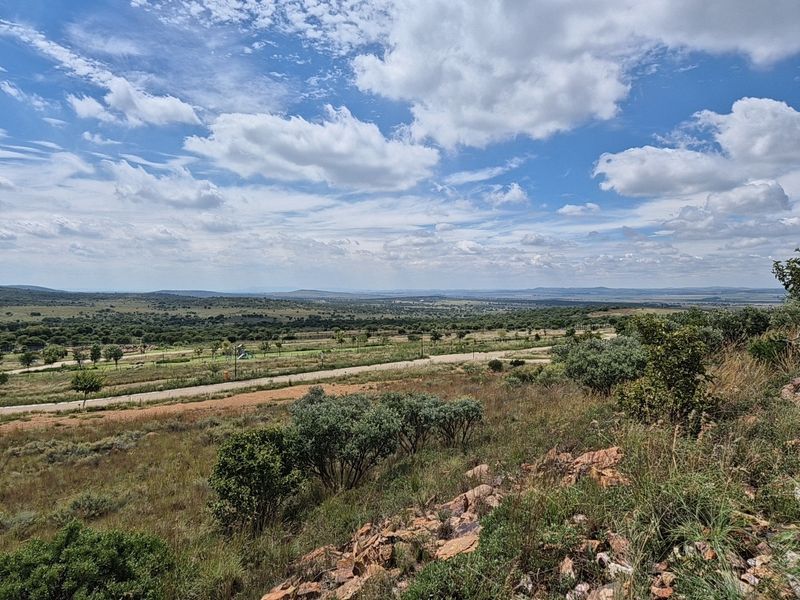 Expansive elevated view overlooking the surrounding natural landscape and residential estate grounds.