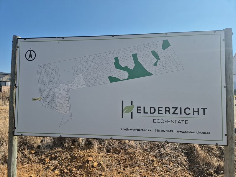 A site map signage board for Helderzicht Eco-Estate, displaying the layout of residential plots and green spaces within the development.