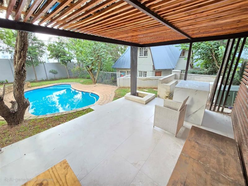Covered patio area featuring a timber pergola, built-in stone counter, and direct access to a private swimming pool and garden.