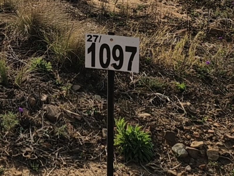 A close-up view of a property marker sign indicating lot number 1097 on a vacant residential plot.