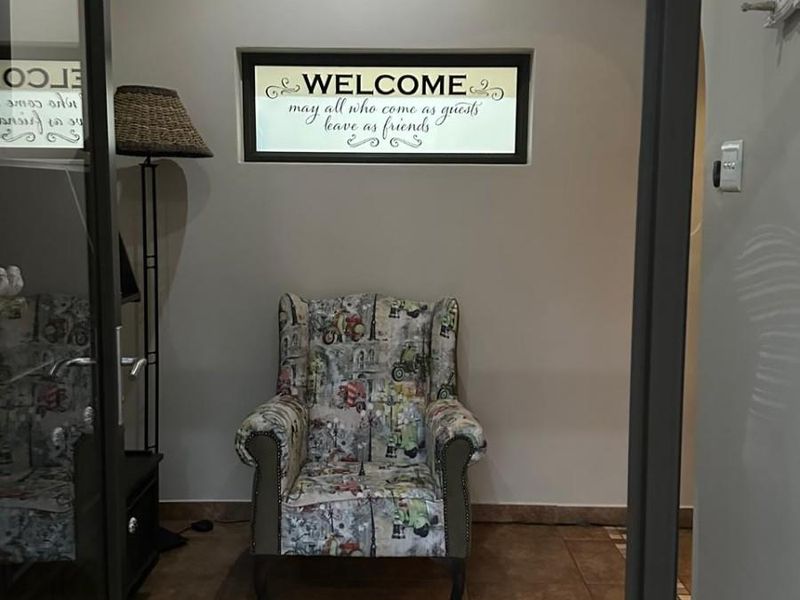 A welcoming entrance foyer featuring tiled flooring and a horizontal transom window, providing a bright and inviting transition into the home.