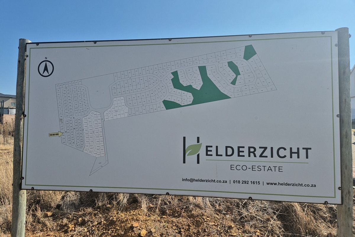 A site map signage board for Helderzicht Eco-Estate, displaying the layout of residential plots and green spaces within the development.