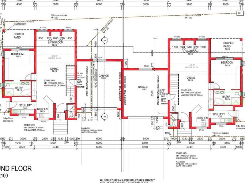 A detailed ground floor architectural plan showing the layout of two mirrored residential units, including kitchen, living, dining, bedroom, and garage areas.