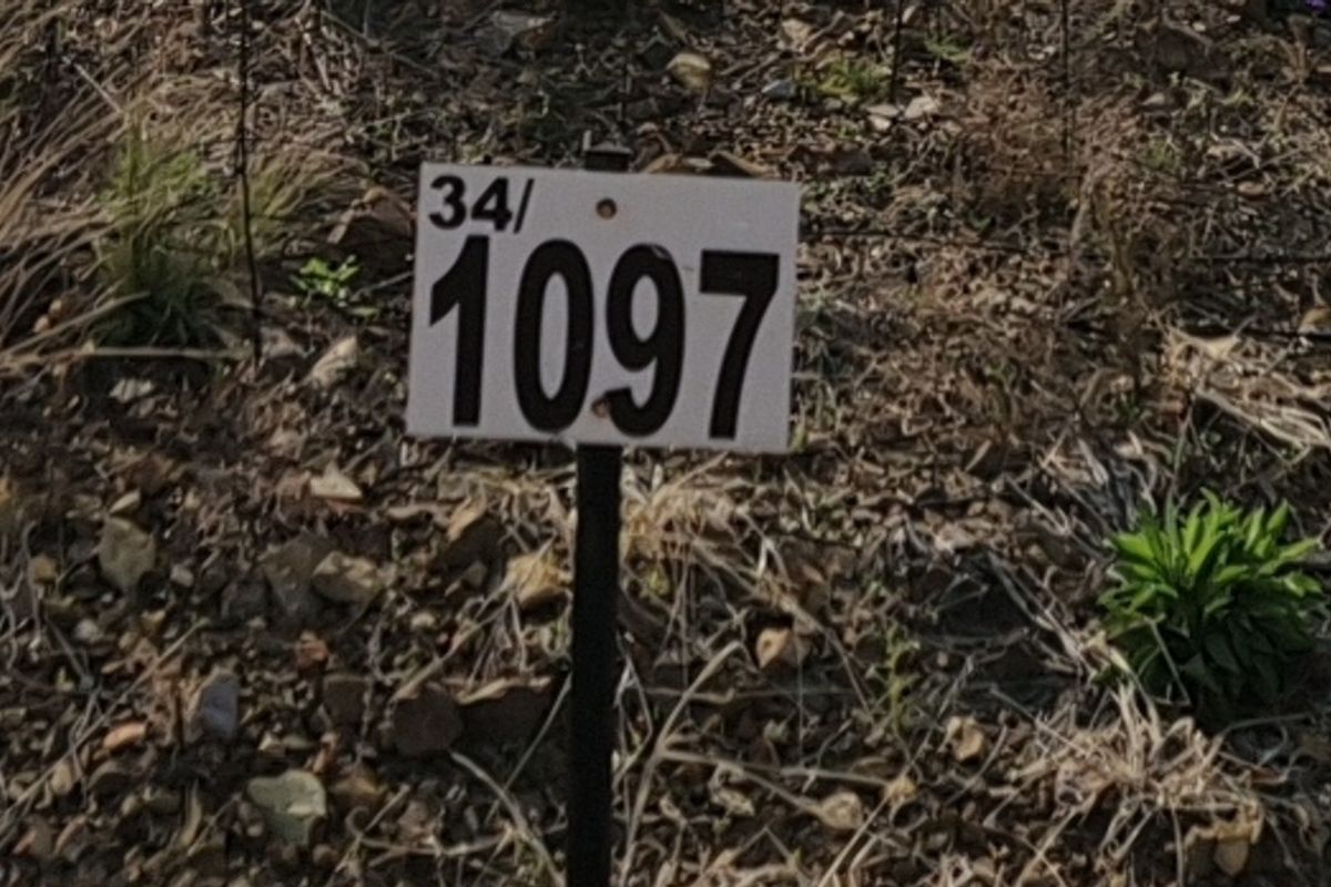 A close-up view of a property identification marker on a vacant residential plot.