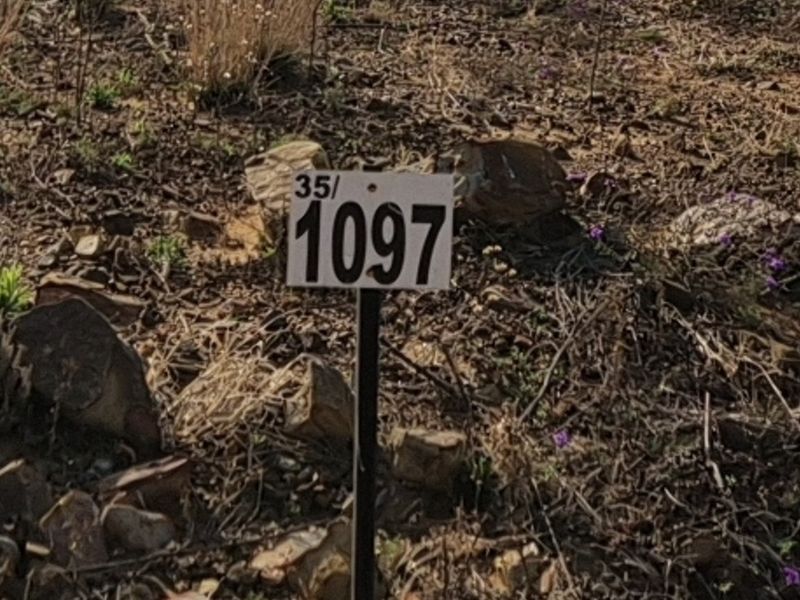 A close-up view of a property marker stake on a vacant residential plot.