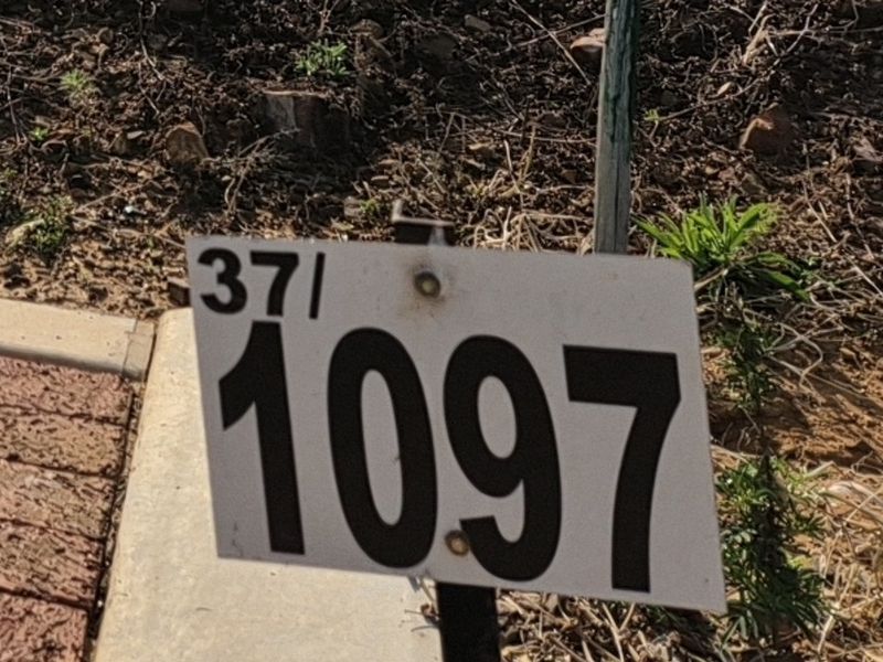 A close-up view of the property address marker located on the residential vacant land plot.