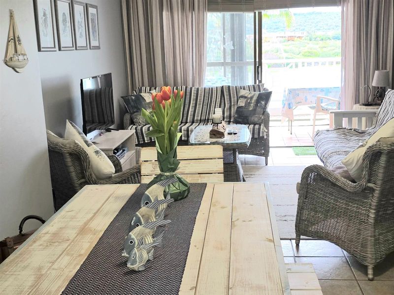 Open plan living and dining area featuring tiled flooring and large sliding glass doors leading to a private balcony.