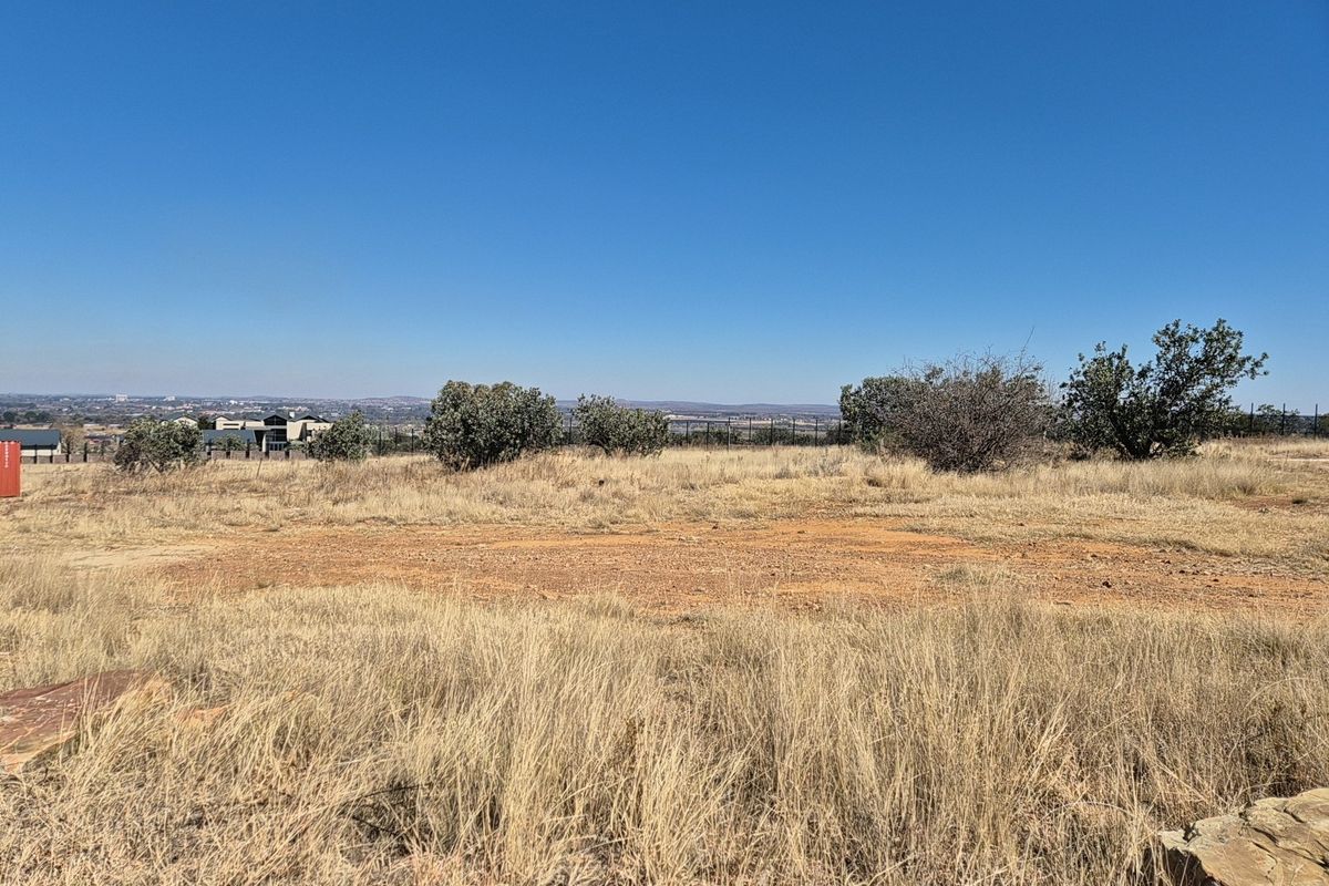 A wide-angle view of the vacant residential land, showcasing the natural terrain, native vegetation, and distant horizon.