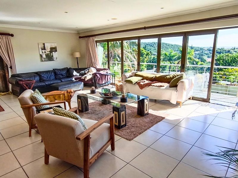 Spacious living room featuring large sliding glass doors that open onto a balcony, providing ample natural light and scenic views.