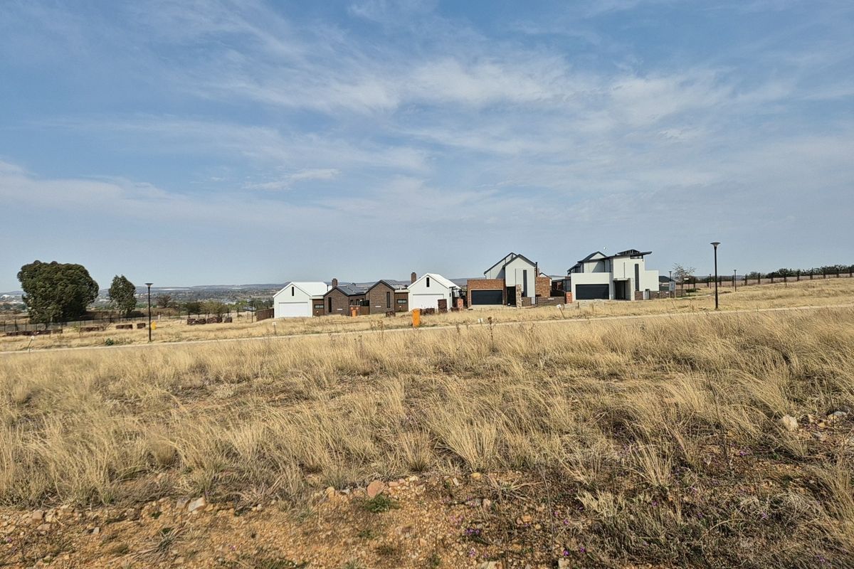A wide-angle view of a residential estate development featuring modern homes set against a natural landscape.