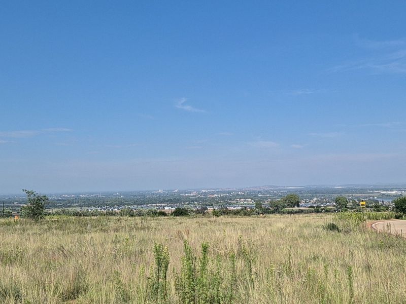 A wide-angle view of the vacant residential land, showcasing the expansive landscape and surrounding area.
