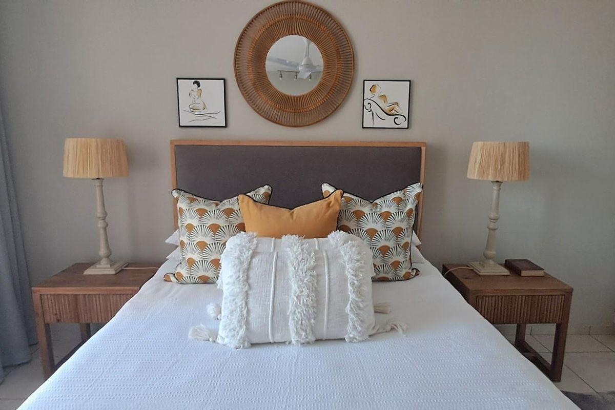A well-maintained bedroom featuring built-in cupboards, neutral wall finishes, and tiled flooring, offering a comfortable and clean living space.