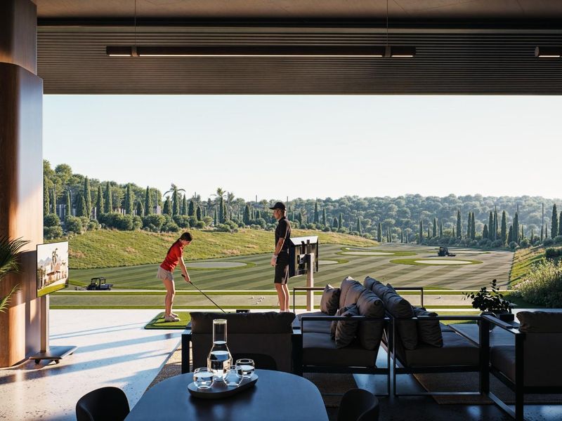 A modern, open-plan indoor-outdoor living space featuring seamless transitions to a private golf course view.