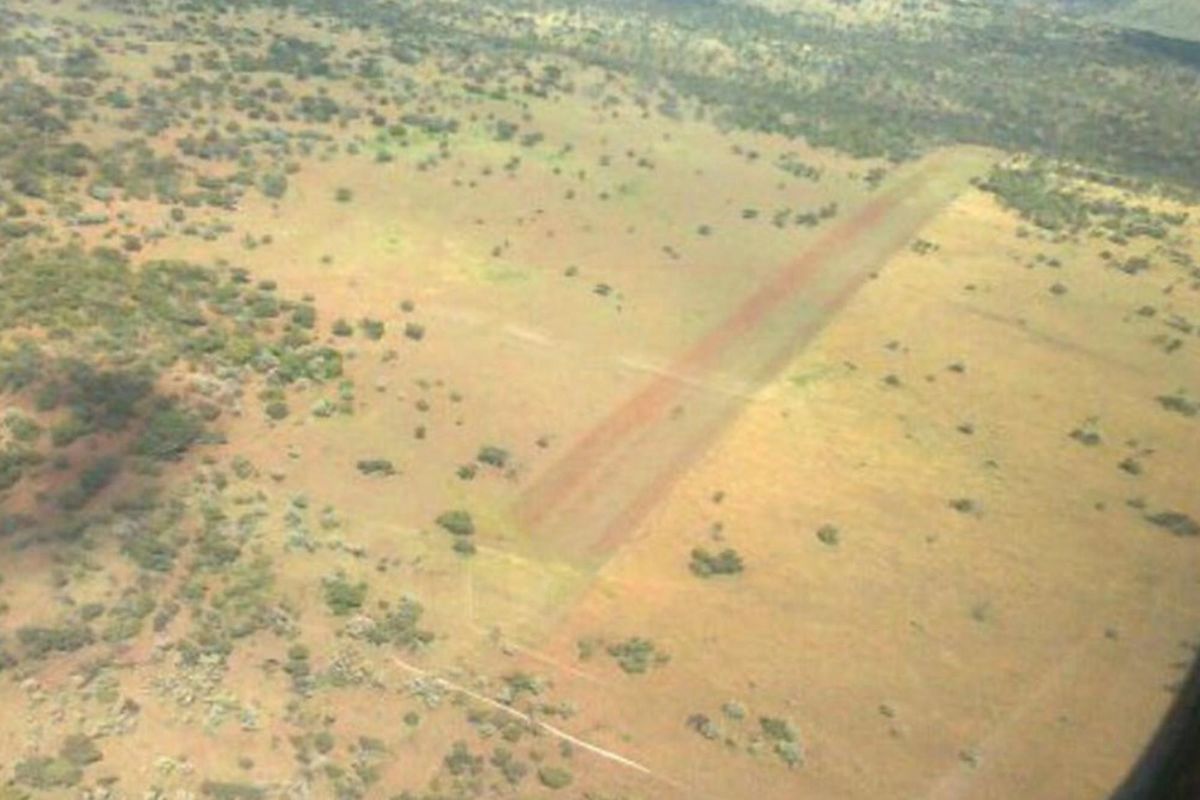 Aerial view of the farm property featuring a private dirt airstrip set within the expansive rural landscape.