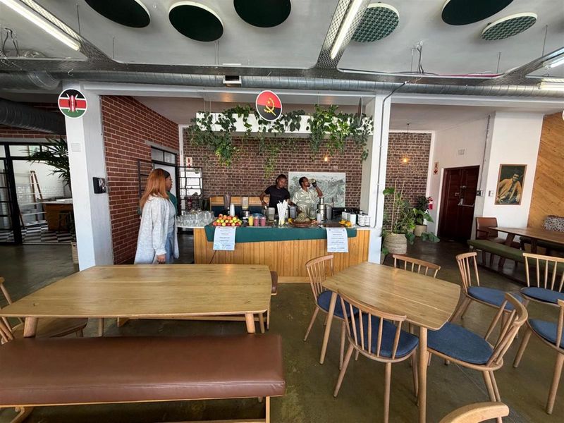 Open plan office space featuring a built-in service counter, exposed brick walls, and industrial-style ceiling finishes.