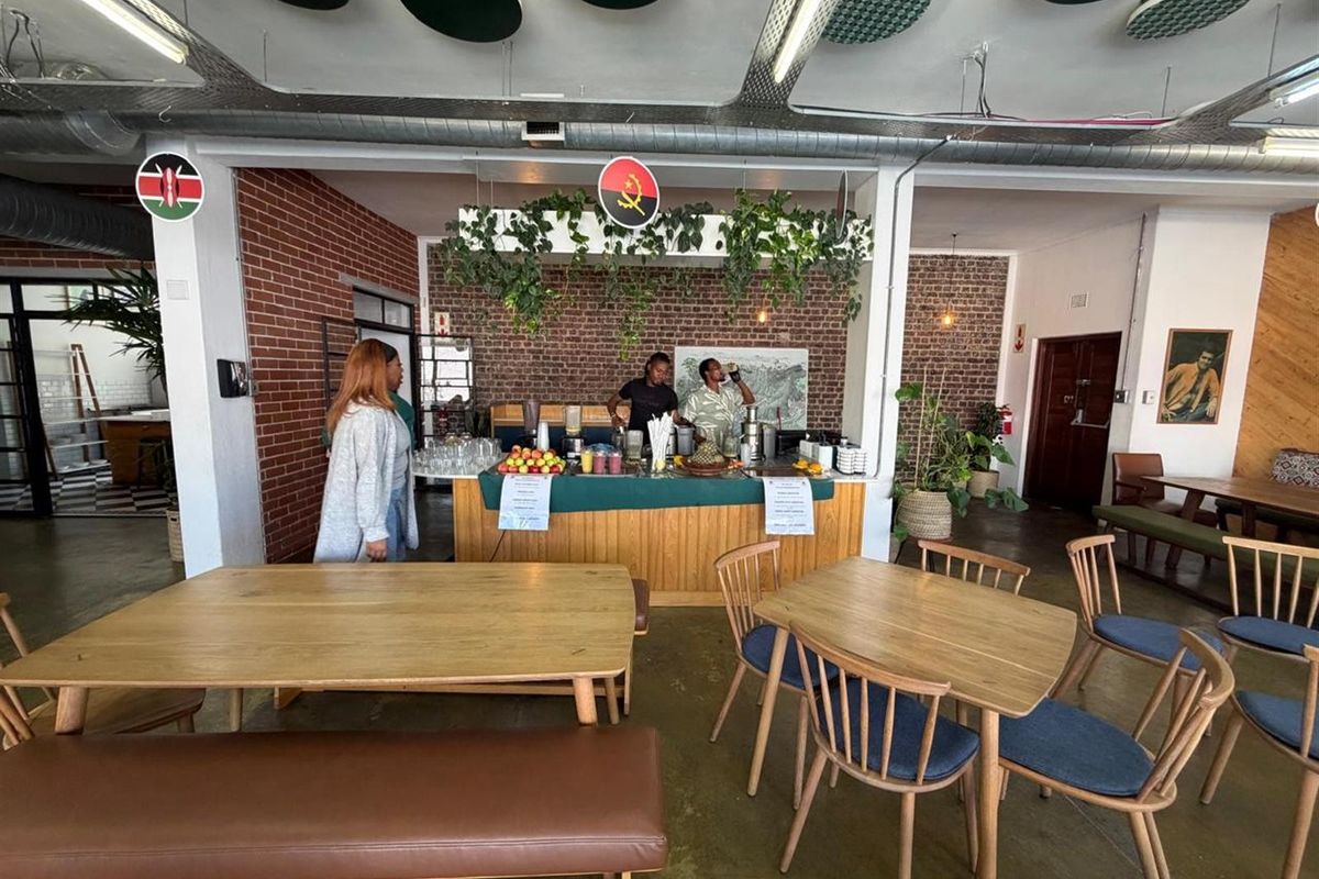 Open plan office space featuring a built-in service counter, exposed brick walls, and industrial-style ceiling finishes.