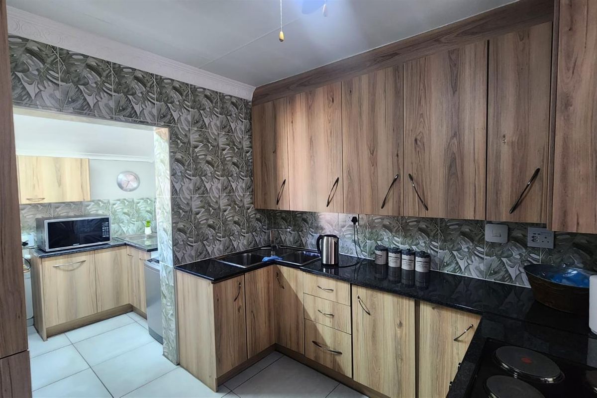 Modern Comfort and Secure Living in Sought-After Pin Oaks - Photo 4