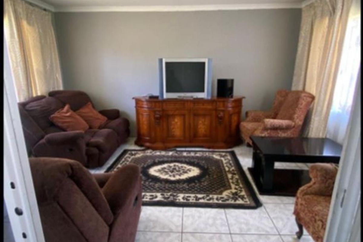 A living room featuring tiled flooring and neutral wall finishes, providing a functional space for relaxation.