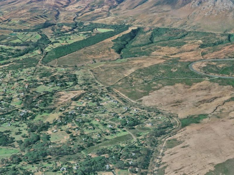 An aerial view of the residential area and surrounding landscape, showcasing the property's location within the broader regional context.