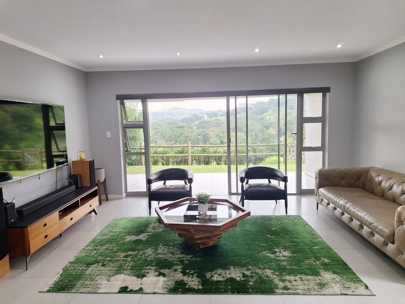 Spacious living room featuring large sliding glass doors that provide natural light and access to the outdoor patio area.