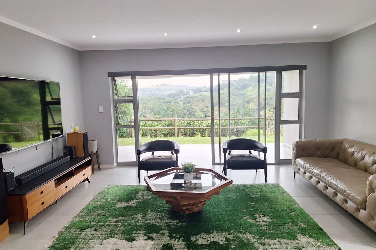 Spacious living room featuring large sliding glass doors that provide natural light and access to the outdoor patio area.