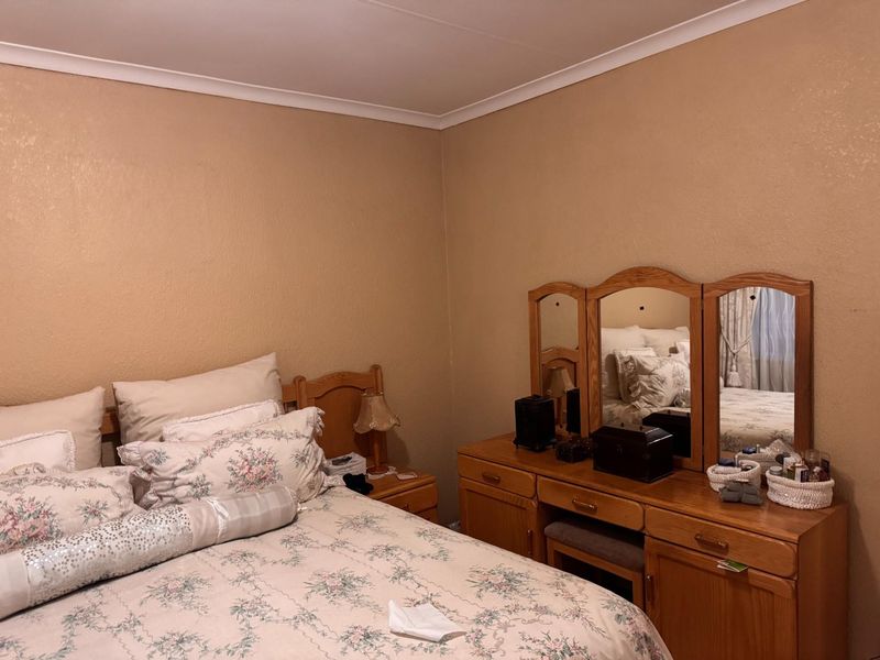A bedroom featuring neutral wall finishes, coving, and skirting boards, providing a functional space ready for modern updates.