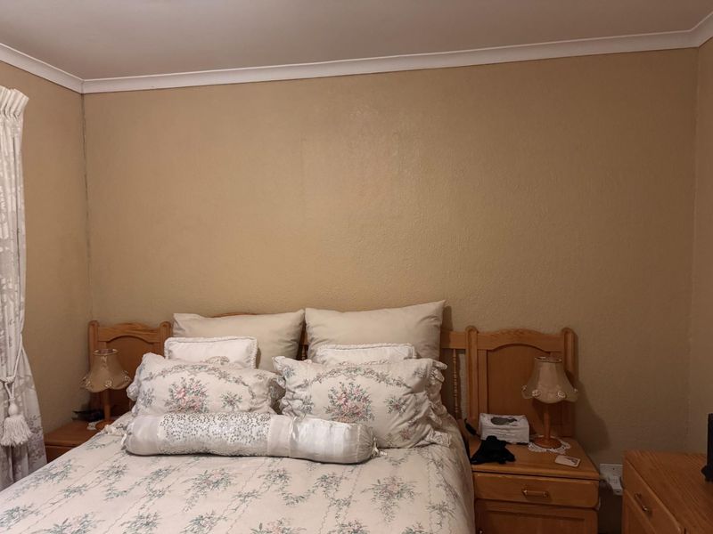 A standard bedroom featuring neutral wall finishes and coving, providing a functional and comfortable sleeping space.