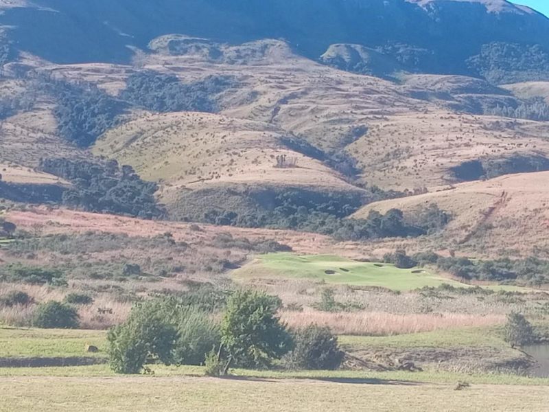 A scenic landscape view showcasing the natural terrain, rolling hills, and surrounding estate environment, highlighting the property's tranquil setting.