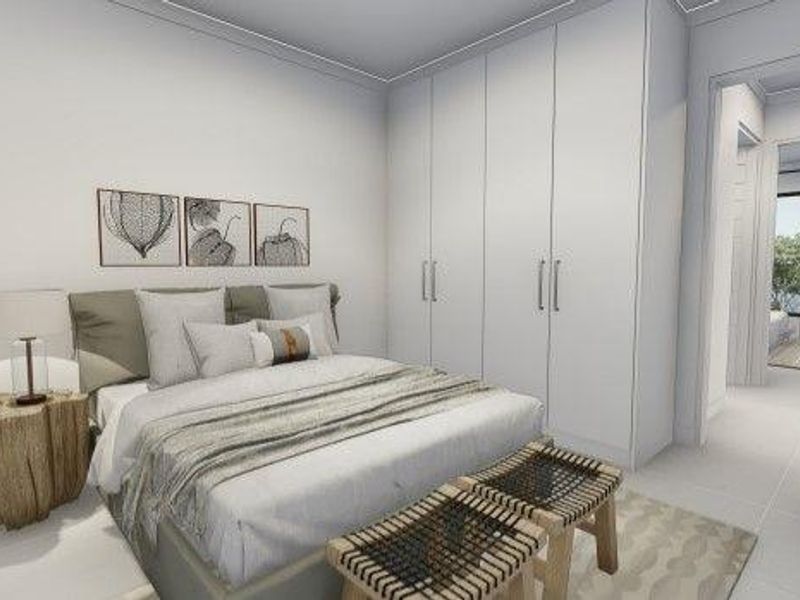 A modern bedroom featuring built-in floor-to-ceiling wardrobes, neutral tiled flooring, and clean architectural lines, leading into a bright hallway.