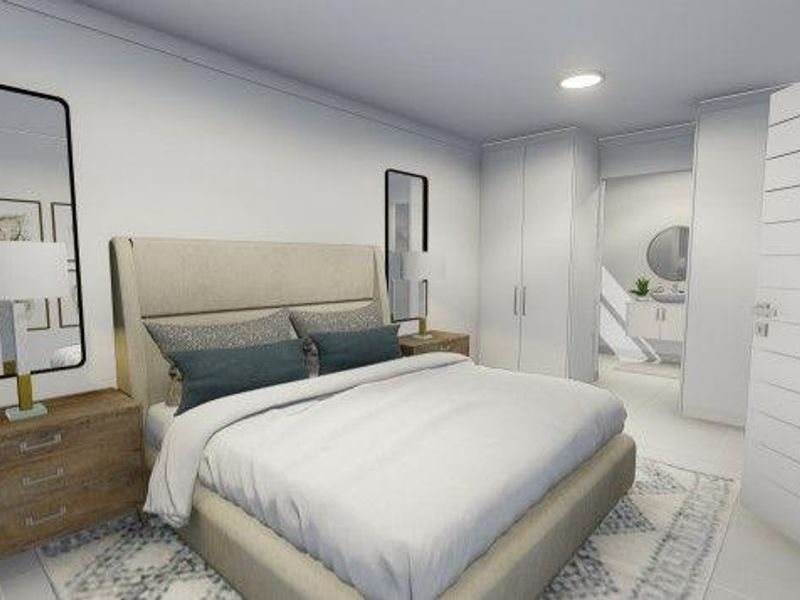 Modern bedroom featuring built-in wardrobes, neutral finishes, and an adjoining en-suite bathroom with contemporary fixtures.