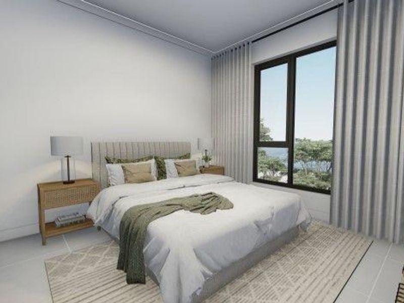 A modern, well-lit bedroom featuring built-in wardrobes, large windows with floor-to-ceiling curtains, and neutral finishes.